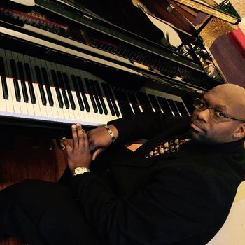 Sitting at the baby grand
