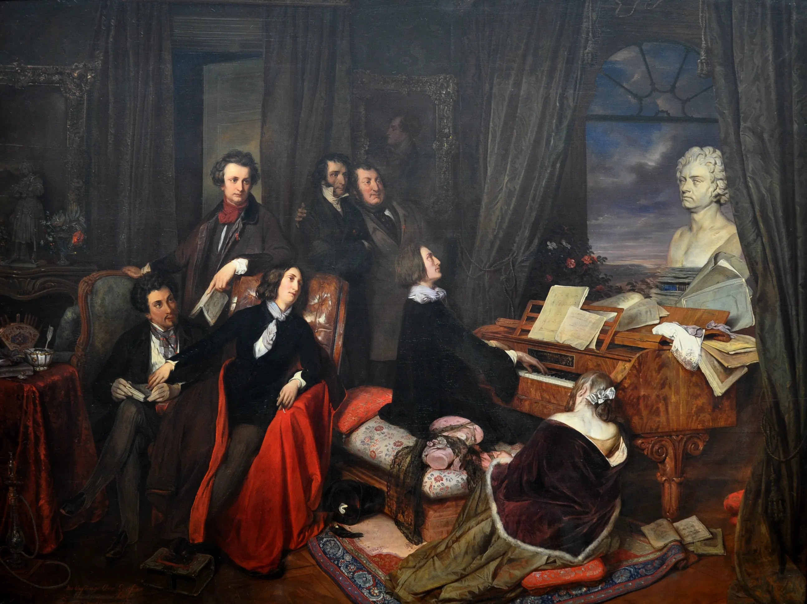 19th-century painting of composer and Pianist Franz Liszt, a young man in black with long brown hair, playing the piano as he gazes at a bust of Beethoven in a dark room with an open window on a stormy sky. A group of men and women sit on chairs or lean against each other listening with rapt attention. One woman, Liszt's mistress Marie d'Agoult, is shown from behind seated on the floor leaning her forehead against the piano.