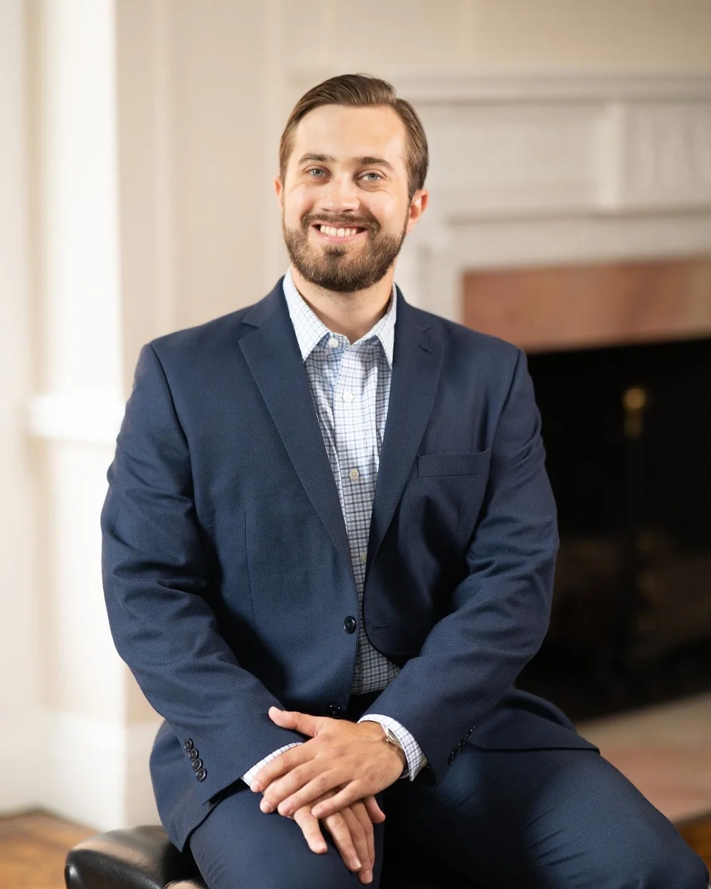 Erik Tofte, a smiling white man with a brown trimmed beard and mustache in a blue suit