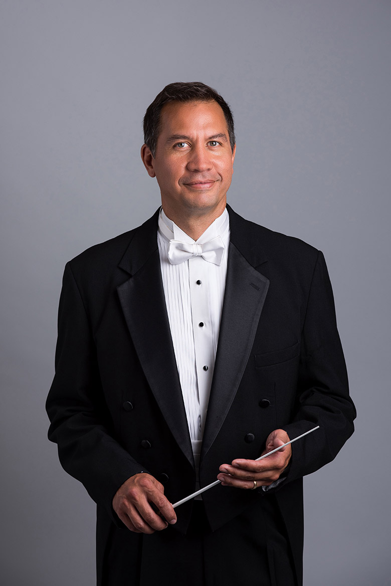 Maestro Daniel Hege, a Native American man in a tuxedo holding a conductor's baton