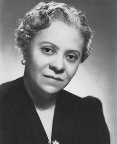 Image: Florence Price, a Black woman with short gray hair in a black blouse in a black and white headshot