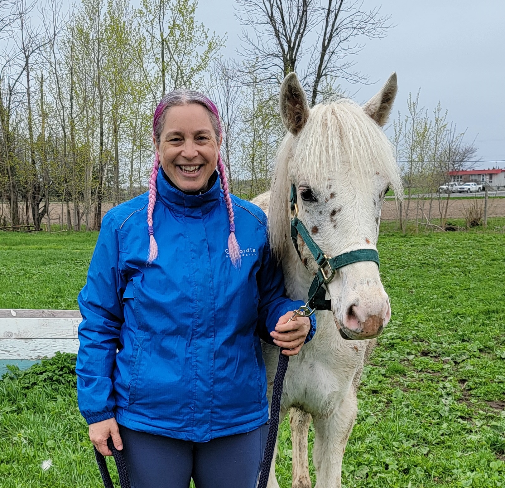 Older Gaby Dufresne-Cyr holding a client's foal after a training session