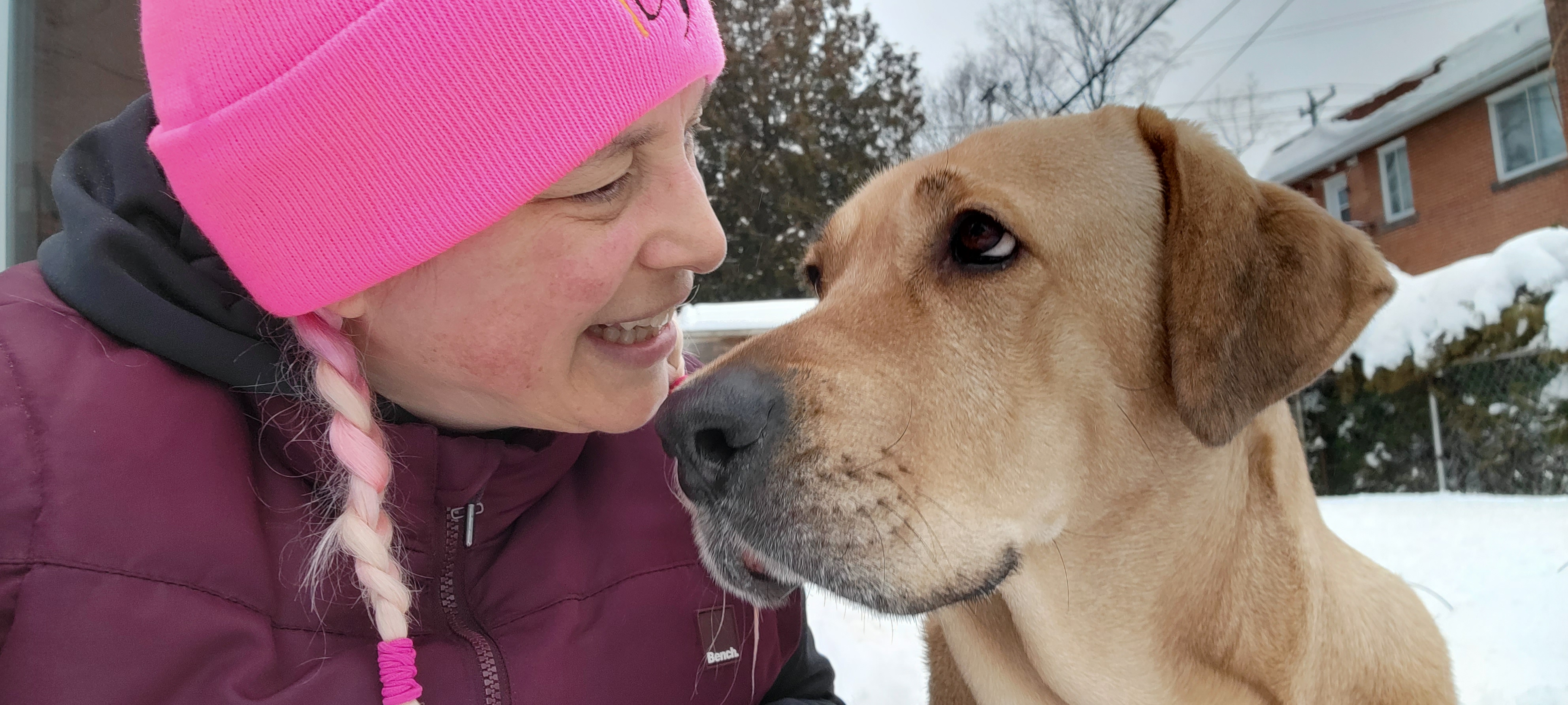 Gaby Dufresne-Cyr with her Broholmer, Hariette, posing outside in the snow looking at one another
