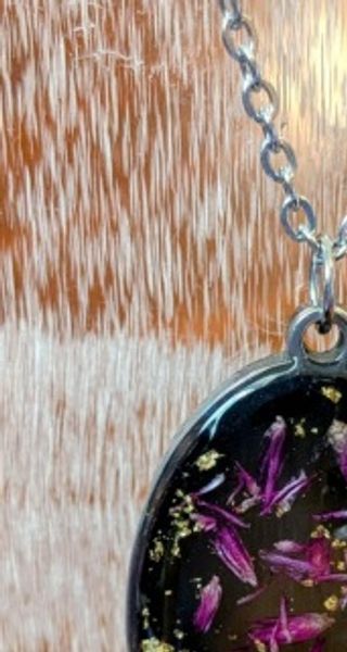 A pendant with purple flower petals