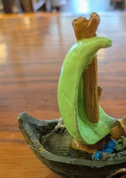 Small toy boat with a leaf as a sail
