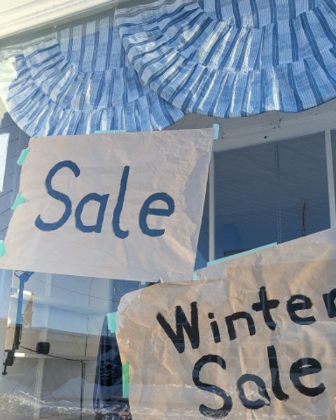 Store windows with Winter Sale signs