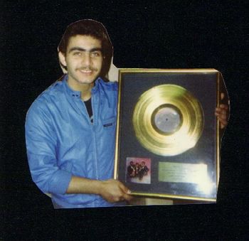 Best friend Ramiz holding up the Whispers gold record for "The Beat Goes On."
