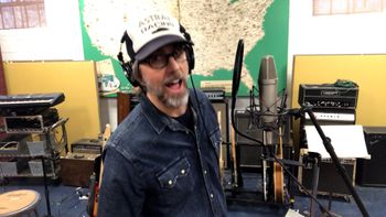 Scott Hall musician and songwriter singing in the studio
