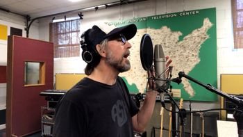 Scott Hall musician and songwriter in the studio singing
