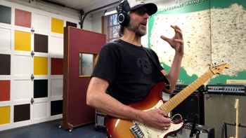 Scott Hall Musician and Songwriter in the studio holding a Fender Stratocaster
