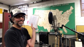 Scott Hall musician and songwriter in the studio laughing
