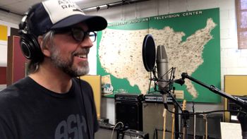 Scott Hall musician and songwriter in the studio smiling
