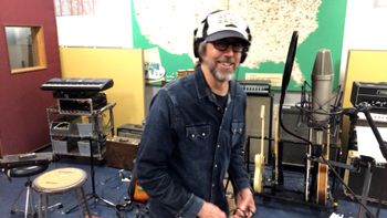 Scott Hall musician and songwriter in the studio laughing
