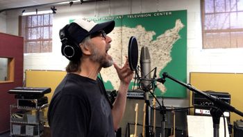 Scott Hall Musician and Songwriter singing in the studio
