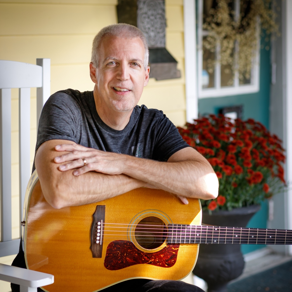 Mike Lucey Sitting on a Porch Rocker