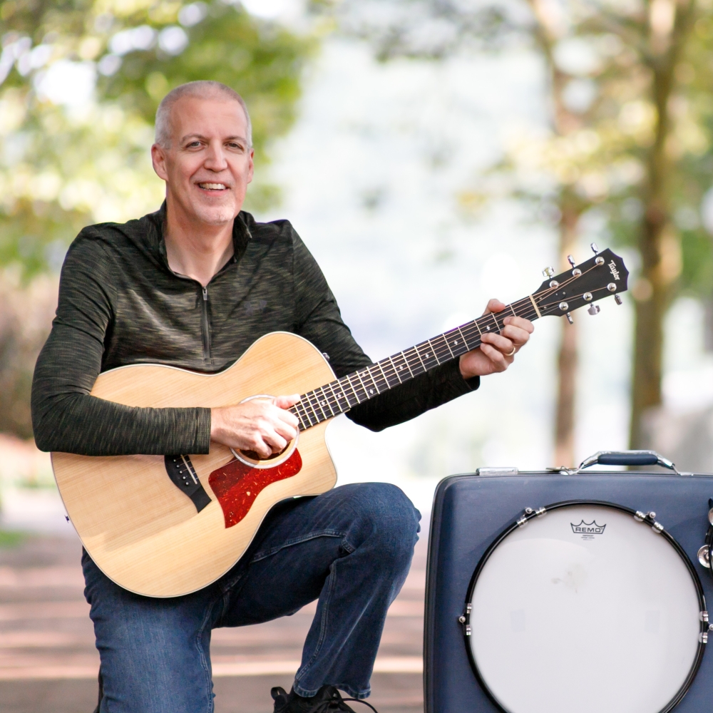 Mike Lucey with Guitar and Suitcase Drumkit