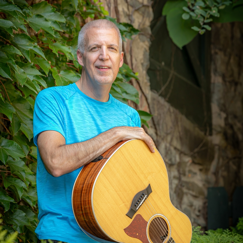 Mike Lucey at Tree with Guitar