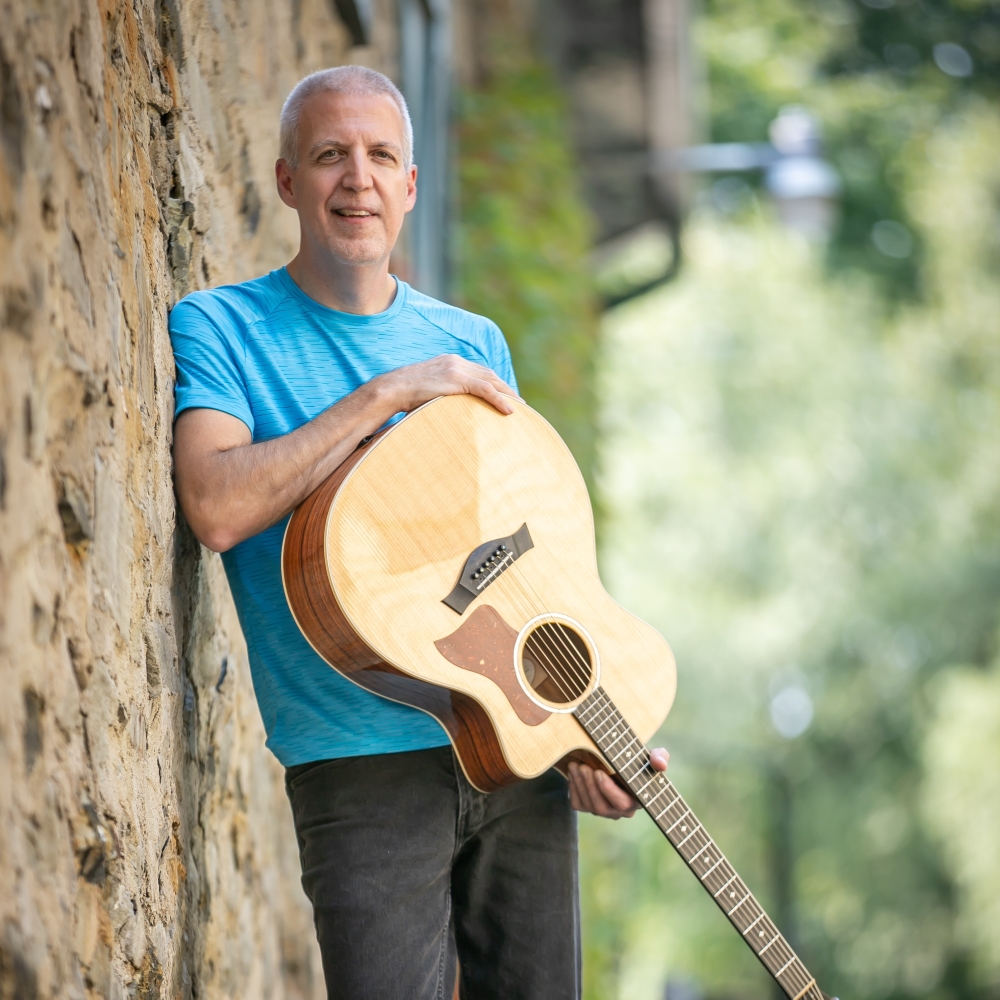 Mike Lucey Leaning on a Stone Wall