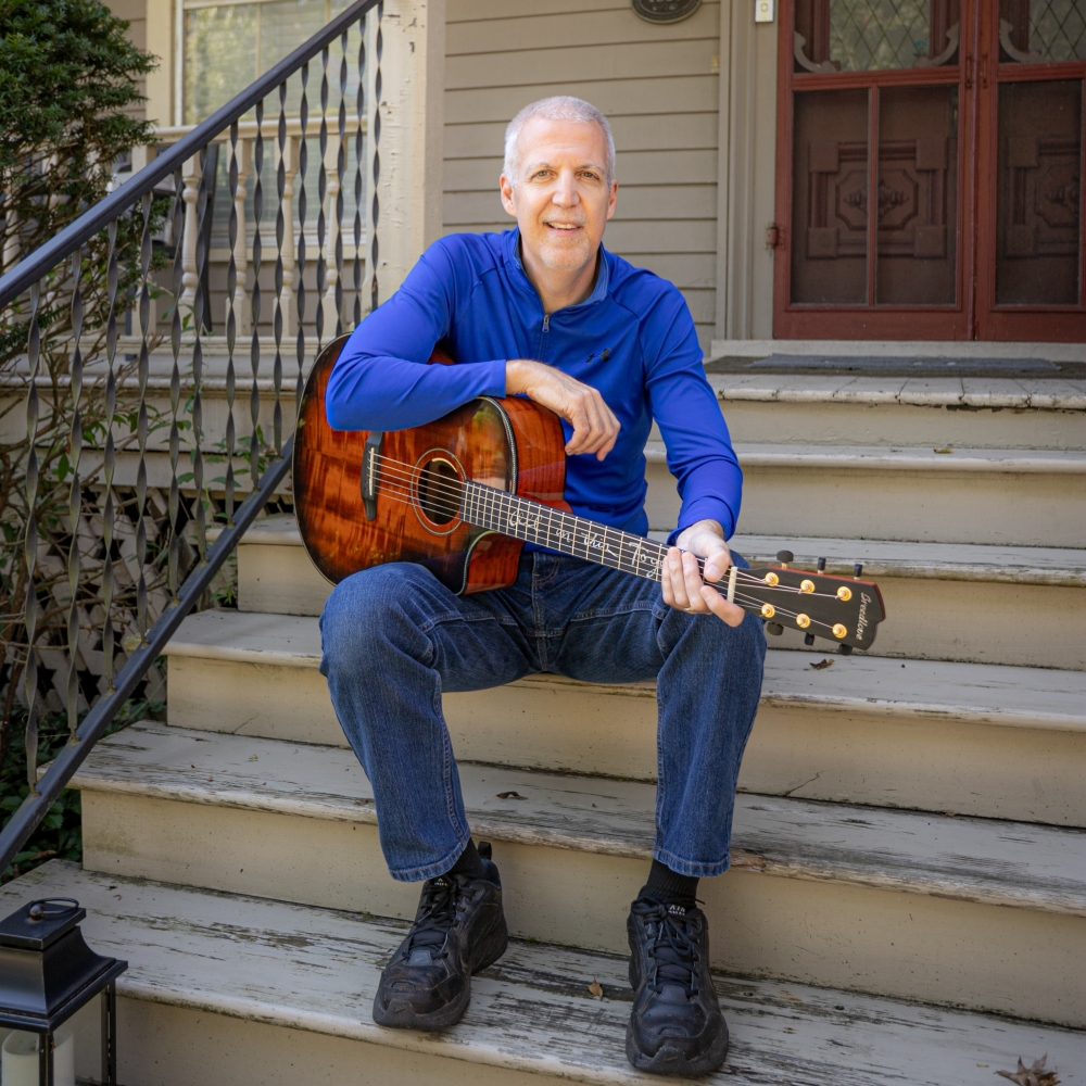 Mike Lucey with Breedlove Acoustic Sitting on Porch Step