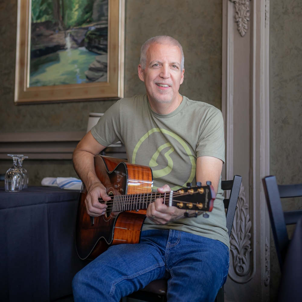 Mike Lucey Sitting at a Restaurant with a Breedlove Acoustic