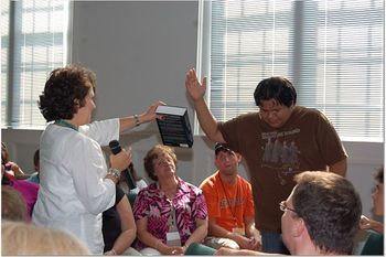 Allison blessing Wes Wesaw with a book of theology after the ordination.
