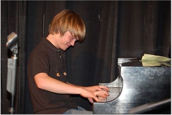 Cody McVey is a former student of the school and is now traveling full time with Monument Quartet. If I am not mistaken, he's around 17 years old.
