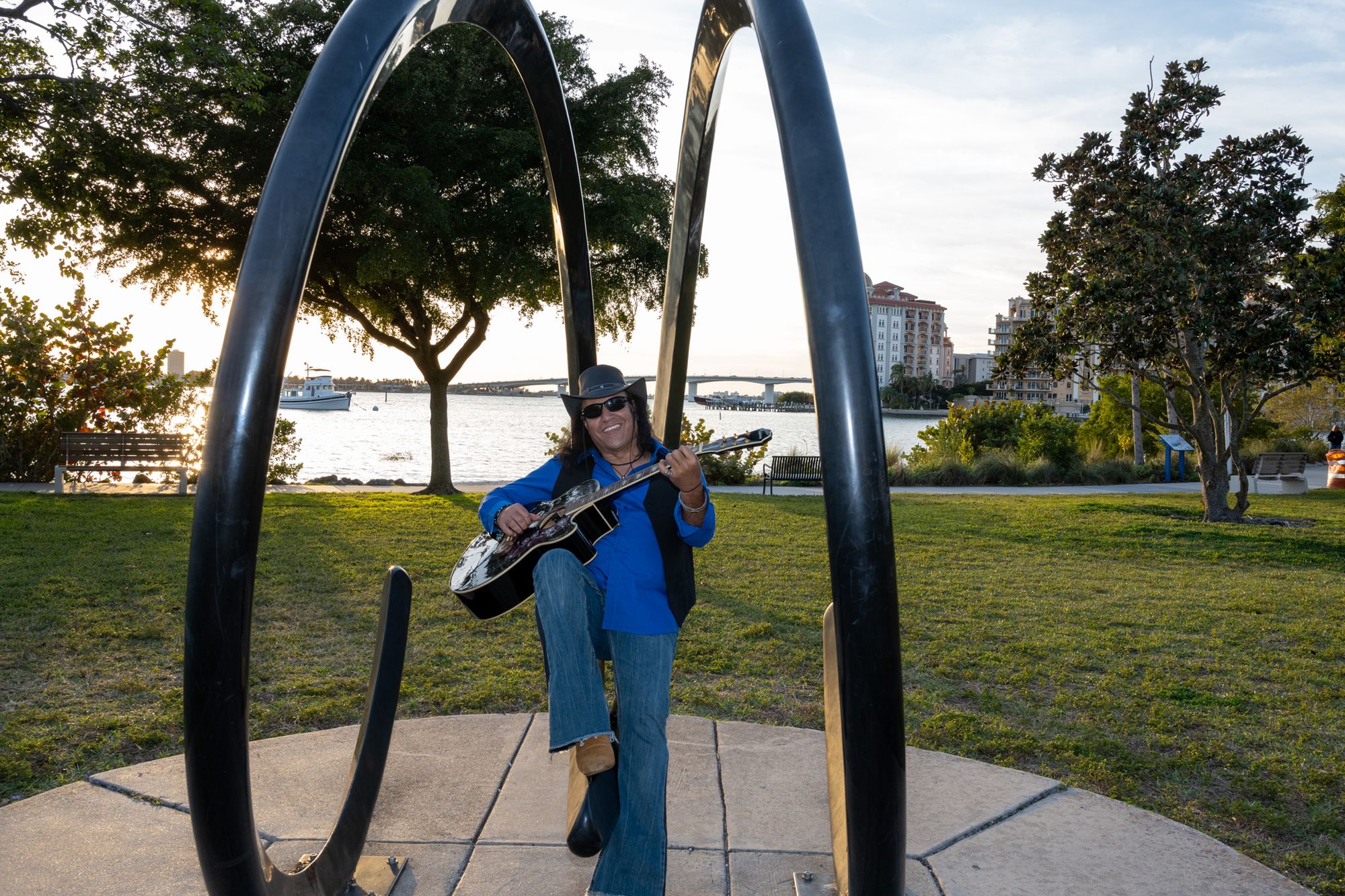 Robert Garcia with guitar at a waterfront location