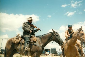 That's me on the buckskin horse checking out Ted Levine playing fiddle on horseback.
He can play!
