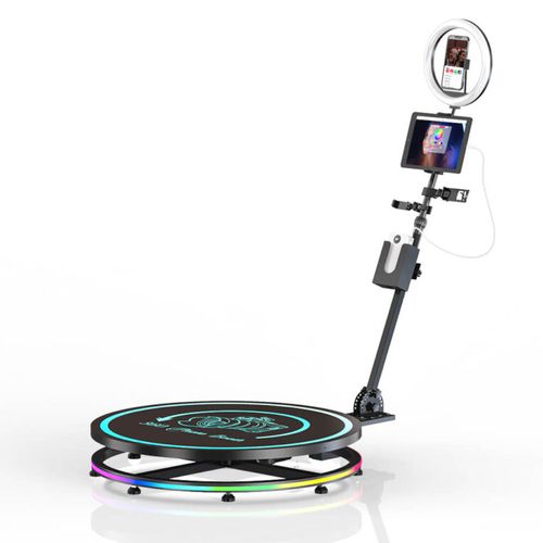 360 photo booth with a circular platform, multicolor lighting, and a rotating camera arm with a ring light.