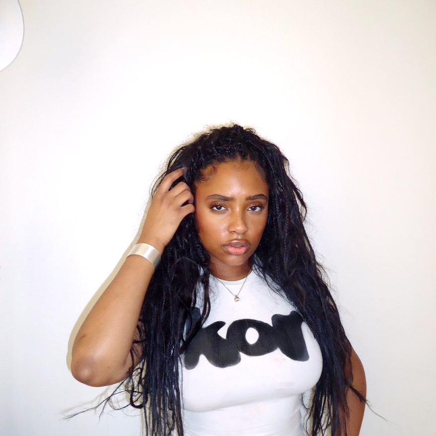 Nostalgic look in Korin’s eyes, wearing a white t-shirt