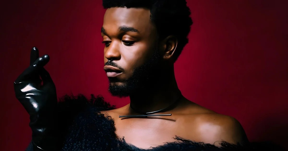 Cakes Da Killa looking fab, snapping fingers, wearing black leather gloves