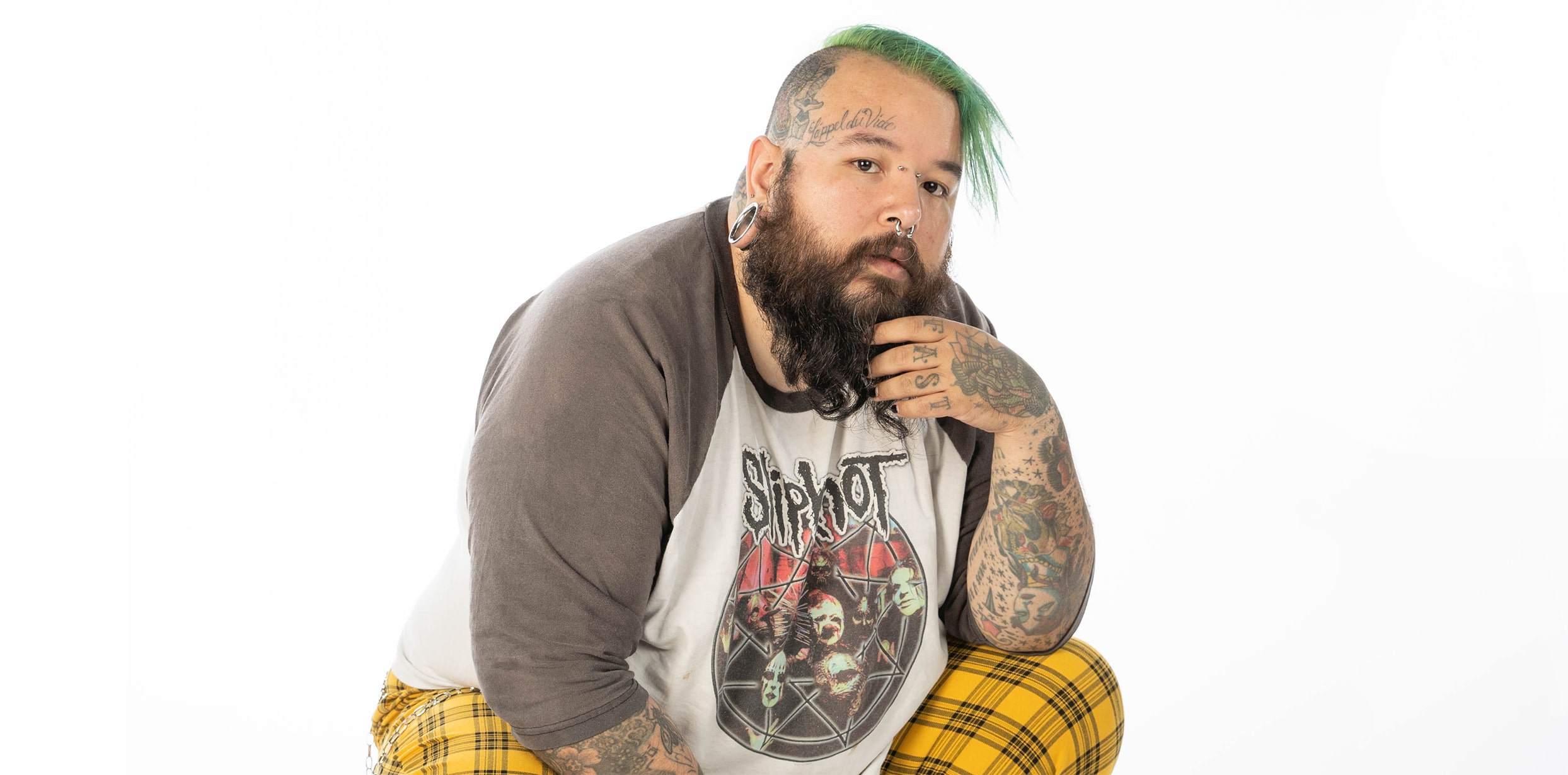 Avant-garde queer rapper Chris Conde with green hair and a slipknot t-shirt