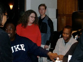 Tracey watching Cedric Dent autograph their new cd
