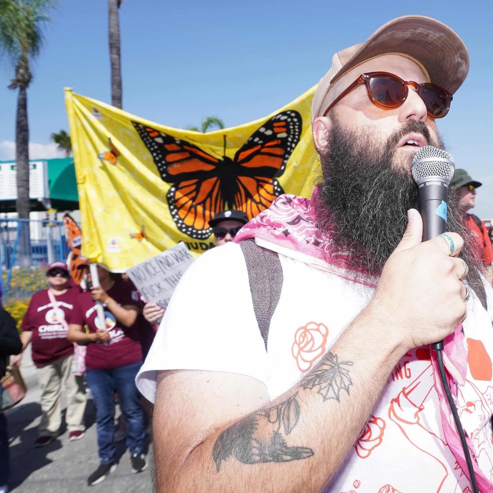 Jonny Miller Jr leading marchers in song at IE MAY DAY International Workers' Day, 05-01-2026, San Bernardino.
