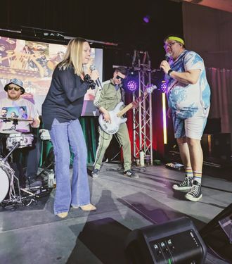High-energy crowd engagement during an Anti-Skip Protection Live Band Karaoke night at a fundraiser gala..