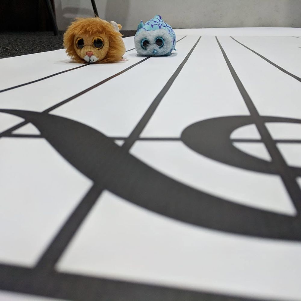 Musical animal toys on a floor piano mat used for playful rhythm activities.