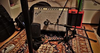 Recording guitar for debut album. Notice the weights and drum bags used to angle the amp properly.

