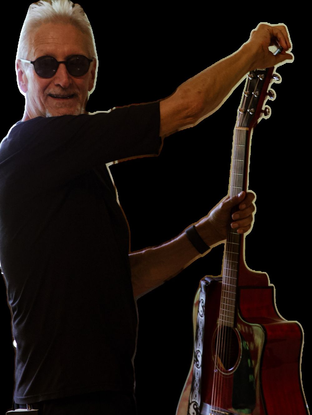 Joe Peters tuning an acoustic guitar