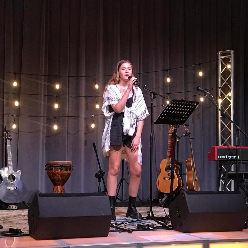 Amber Wolf performing on stage at a SAMI event
