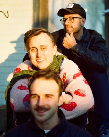 Front: Ian Strobino (he/him, drums). Middle: Margot Biever (she/her, guitar). Back: Zach Goforth (he/him, bass).
