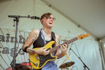 Margot Biever (she/her) on guitar at Nashville Pride 2024
