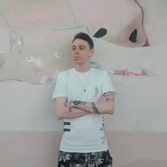SaintBySix electronic music producer portrait in front of mural wall