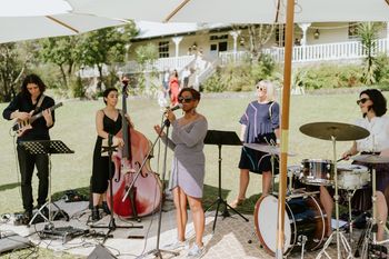 Ms. G with four piece band performing on Athol Hall lawn at Bradley's head, 2022.
