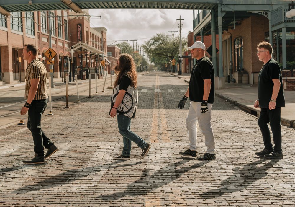 MoonShine Abby band walking in Tampa Bay, rock and cover band group photo inspired by Abbey Road style