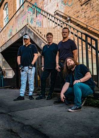 MoonShine Abby band walking on railroad tracks with instruments, Tampa Bay rock and cover band press photo