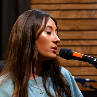 Headshot of Latin pop artist Briana singing during her "Side-B Live Studio Concert"