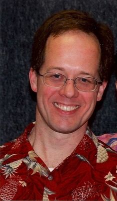 Former member and first call substitute Scott Stroman sings and plays lead guitar or bass. Likes Buddy Holly. He has seniority. Played in "Beatles Forever" as George. Also plays with "The Griswaldz".
