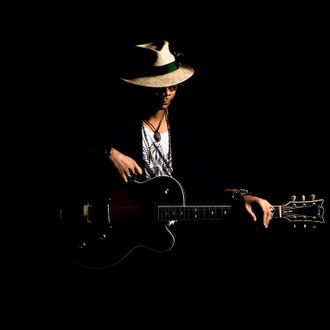 Yat Mellow Blues is a jazz and blues pop cafe guitarist with laid-back beach vibes.