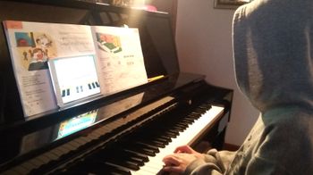 Young student making time to play music from a fun educational app!
