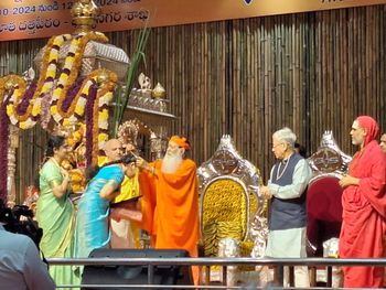 Pujya Appaji blessing Sarvepalli Sisters with Gold Chains after conferring them with Asthana Vidushi Titles
